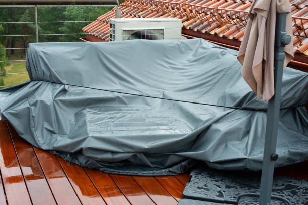 Terrace furniture Cover protecting outdoor furniture from rain. Rainy day.